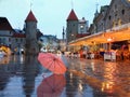 Tallinn  Old Town Panorama  city light  pink umbrella  rainy season street evening lightening  blurring bokeh city  people walking Royalty Free Stock Photo