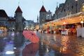 Tallinn  Old Town Panorama  city light  pink umbrella  rainy season street evening lightening  blurring bokeh city  people walking Royalty Free Stock Photo