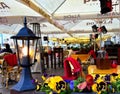 Tallinn old town 14,04,2020, street cafe table with lantern light flowers decoration red blanket on chair at evening in medieva