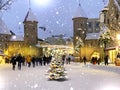 Tallinn Old town  Viru gate snowy weather  Christmas tree on   street people walk bokeh blurred light festive city shops holiday i Royalty Free Stock Photo