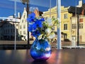 Tallinn Street cafe table on top  blue glass vase with wild blue white cornflowers and daisies  flowers , national Estonia republi Royalty Free Stock Photo