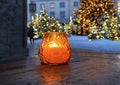 Tallinn town hall square yellow candle cup on wooden table top and Christmas tree  blurred light travel to Estonia Royalty Free Stock Photo