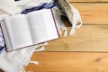 Tallit, shofar and open Torah on wooden table, flat lay. Rosh Hashanah celebration