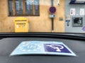 Handicapped card in car at disability parking space