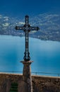 Iron catholic cross overlooking lake