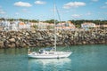 Sailboat leaves the marina of Bourgenay Harbor