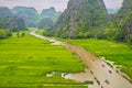 Tourists travelled along a stream inside ripen rice fields.
