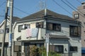 A residence balcony with hung laundered blankets, strategically positioned to facilitate