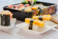 Tamagoyaki sushi or sweet egg on rice and seaweed wrap on square white plate. Delicious japanese food Royalty Free Stock Photo