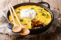 Tamale pie casserole served with sour cream close-up in a pan. horizontal