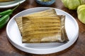 Tamales, traditional dish of the cuisine of Mexico, on a wooden background