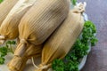 Tamales in white plate on Wooden table