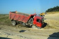 A dump truck kamaz got stuck in the mud on the side of the road