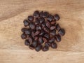 Tamarind seeds formed in circle on wood background