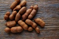 Tamarindo tamarind fruits ripe on brown wood