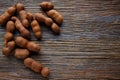 Tamarindo tamarind fruits ripe on brown wood