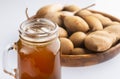 Tamarindus indica - Delicious sweet drink, tamarind juice and ice on a rustic wooden table