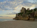 Tamarit castle at Tamarit beach with clouds at sunset and nobody on the beach Royalty Free Stock Photo