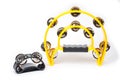 The tambourine is large semicircular yellow and a small black tambourine for attaching to the arm or leg of the musician