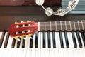 Tambourine and neck of guitar on piano keyboard. Royalty Free Stock Photo