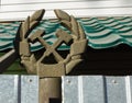 Railway emblem: Crossed hammer and adjustable wrench made of Soviet metal on an old street fence post