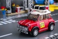 Lego 1967 Mini Cooper S Rally car by LEGO Speed Champions on road baseplate near pit stop station