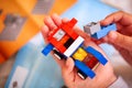 Child building Lego car. There are some Lego instructions on ba