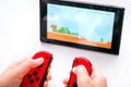 Kid with Joy-Cons playing Super Mario Maker 2 video game on Nintendo Switch console