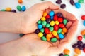 M&Ms candy in woman hands. White background