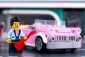 Lego pink 1950s-style convertible and rock n roll star minifigure with guitar near