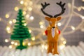Lego Reindeer minifigure against Christmas tree and Christmas light background
