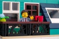 Lego minifigure businessman standing on a balcony and waving his hand Royalty Free Stock Photo