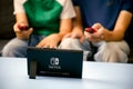 Man and kid playing Nintendo Switch video game console