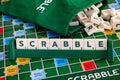 Word Scrabble from letter tiles in tile rack on gameboard with