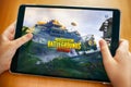 Teenager going to play PlayerUnknown`s Battlegrounds PUBG Mobile mobile game on iPad Royalty Free Stock Photo