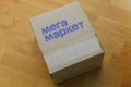 A Megamarket cardboard box. The word Megamarket on the box written in Russian. Megamarket is a Russian service for online shopping Royalty Free Stock Photo