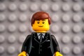 Portrait of Lego businessman minifigure with Lego gray baseplate background