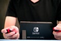 Man playing Nintendo Switch video game console.