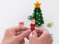 Tambov, Russian Federation - September 26, 2023 A young boy holding a Lego Santa Claus minifigure in his hands over a Christmas Royalty Free Stock Photo