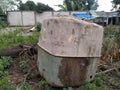 Tambun, Bekasi, Indonesia - Oktober 19, 2020 : The water tank lying in the garden area is empty Royalty Free Stock Photo