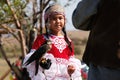 Almaty / Kazakhstan - 09.23.2020 : A little girl in Kazakh national dress holds a Balaban Falcon in her arms