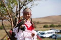 Almaty / Kazakhstan - 09.23.2020 : A little girl in Kazakh national dress holds a Balaban Falcon in her arms