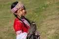 Almaty / Kazakhstan - 09.23.2020 : A little girl in Kazakh national dress holds a Balaban Falcon in her arms