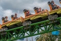 People amazing terrific Cheetah Hunt rollercoaster on lightblue cloudy sky background 49