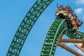 People amazing terrific Cheetah Hunt rollercoaster on lightblue cloudy sky background 70