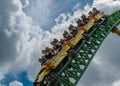 People having fun terrific Cheetah Hunt rollercoaster on lightblue cloudy sky background 64 Royalty Free Stock Photo