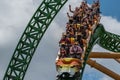 People having fun terrific Cheetah Hunt rollercoaster on lightblue cloudy sky background 33 Royalty Free Stock Photo