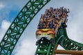 People having fun terrific Cheetah Hunt rollercoaster on lightblue cloudy sky background 50 Royalty Free Stock Photo