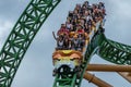 People having fun terrific Cheetah Hunt rollercoaster on lightblue cloudy sky background 31 Royalty Free Stock Photo