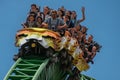 People having fun terrific Cheetah Hunt rollercoaster on lightblue cloudy sky background 72. Royalty Free Stock Photo